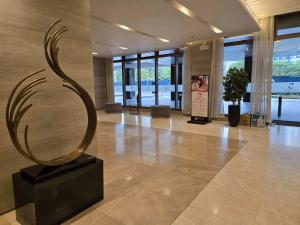 a sculpture in a lobby of a building at Chic Urban Escape at S Residence Tower 3 in Manila +61 photos