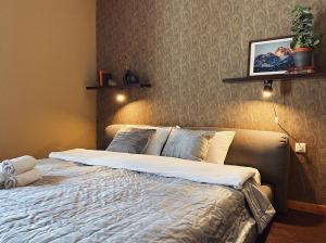 a bedroom with a bed in a room with a wall at Alexa Mountain Homes in Kok-Shoky +45 photos