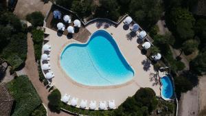 an aerial view of a pool with a resort at Les Hauts de Santa Giulia in Porto-Vecchio
