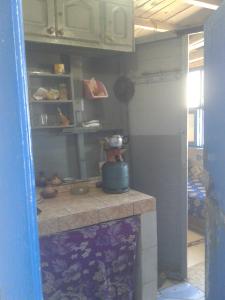 a kitchen with a counter in a room at Grotte Panoramique Atlantique d'Aglou in Zaouia Sidi Ouaggag