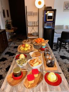 a table topped with lots of different types of food at LES VOLETS ROUGES - Hôtel Cassis - Situé dans le Parc National des Calanques - Parking Gratuit in Cassis +29 photos