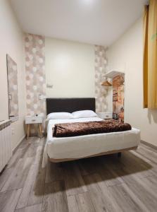 a bedroom with a large bed and a wooden floor at JQC Rooms in Madrid