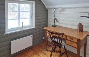 a desk and chair in a room with a window at Beautiful Home In Tranås With Ethernet Internet in Tranås