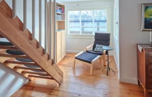 a living room with a staircase and a chair at Beautiful Home In Tranås With Ethernet Internet in Tranås
