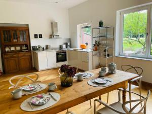 a kitchen with a wooden table and chairs in a room at Ferienwohnung Anstois in Kall