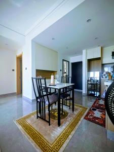 a dining room with a table and chairs at Skyline Luxury 17th-Floor 1BR near Junction Mall - City Views, Pool, Gym & Full-Body Massage Chair in Nairobi