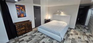 a bedroom with a bed and a painting on the wall at hello dole in Dole