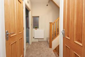 a hallway with wooden doors and a stairway at St John's Hill Apartments in Shrewsbury