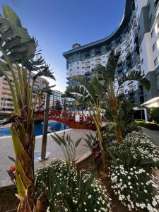 a resort with a pool and some plants and buildings at Serenity Residence duplex in Alanya
