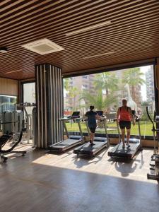 a group of people riding on treadmills in a gym at Serenity Residence duplex in Alanya