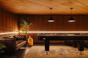 a billiard room with a pool table and a couch at Leonardo Eden Hotel Amsterdam City Center in Amsterdam