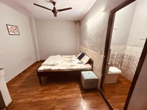 a small room with a bed and a toilet at BTS STAY- Singh Niwas in Ghaziabad