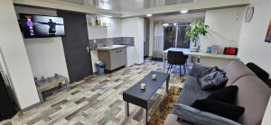 a living room with a couch and a kitchen at hello dole in Dole