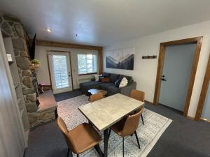 a living room with a table and a couch at The Meadows- Charming 1BD2BA Ski Condo in Kirkwood