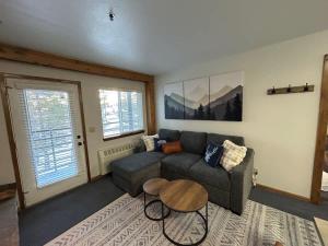 a living room with a couch and a table at The Meadows- Charming 1BD2BA Ski Condo in Kirkwood +40 photos
