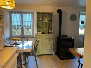 a kitchen with a table and a stove at La p'tite Maison in Vitrac
