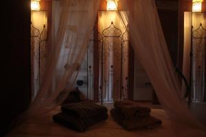 a bedroom with curtains and a bed with two blankets at leschambresdanne in Chameyrat +5 photos