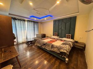 a bedroom with a large bed and a table at The River Edge in Pahalgām +3 photos