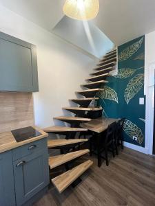 a staircase in a room with a table and a dining room at Les Sources Vichy in Vichy