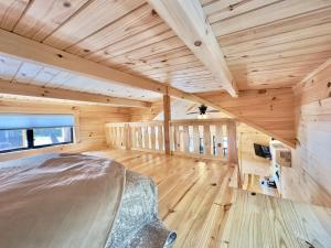 a bedroom in a log cabin with a bed in it at Cozy Coastal Cabin 1 in Steuben