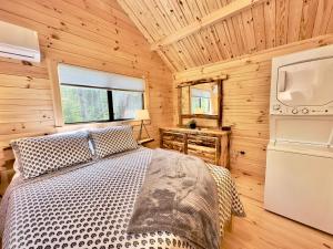 a bedroom with a bed in a wooden cabin at Cozy Coastal Cabin 1 in Steuben