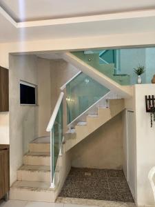 a glass staircase in a house at Casa completa com 3 quartos,ar e garagem in Sobral