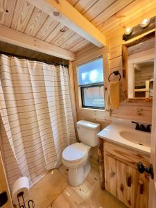 a bathroom with a toilet and a sink at Cozy Coastal Cabin 1 in Steuben +20 photos
