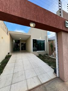 a large building with a walkway in front of it at Casa completa com 3 quartos,ar e garagem in Sobral
