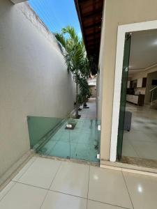 a glass door of a building with palm trees at Casa completa com 3 quartos,ar e garagem in Sobral