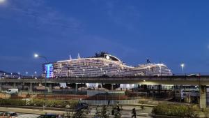 a cruise ship on a bridge over a street at Queen Barbara in Genoa