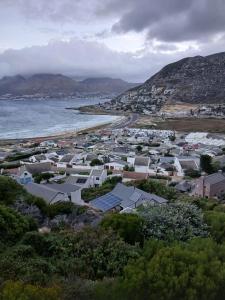 a view of a town with a beach and houses at DigiStay in Simonʼs Town