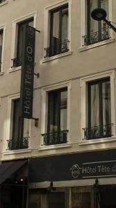 a hotel sign on the side of a building at Hôtel Tête d'or in Lyon
