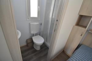a small bathroom with a toilet and a window at VILLAGGIO TURISTICO LA FOCE SpA in Toscolano Maderno +12 photos
