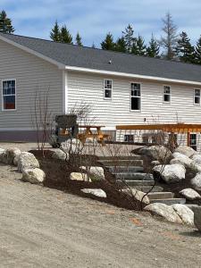 a house with rocks in front of a building at Huckleberry Lane Retreat in Bernard