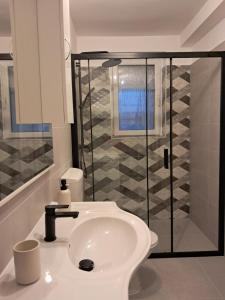 a bathroom with a sink and a glass shower at Holiday Home Manuela in Fažana