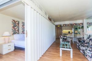 a room with a bed and a couch and a table at Ilikai Tower 1842 in Honolulu