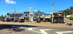 a building on the side of a street with a cross at Hotel Querência in Dionísio Cerqueira