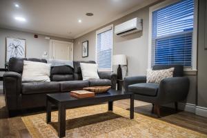 a living room with a couch and a table and a chair at 92179 Newfoundland & Labrador Limited in St. John's