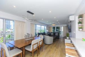 a dining room and living room with a table and chairs at Ilikai Tower 525 in Honolulu