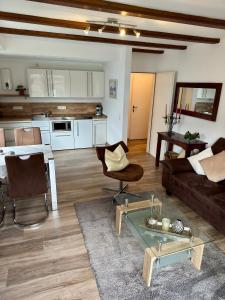 a living room with a couch and a table at Haus Edeltrud - Ferienwohnung Moselufer in Bernkastel-Kues