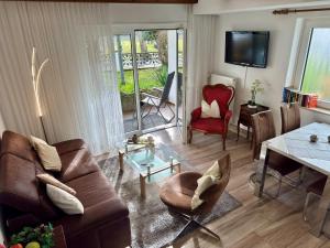 a living room with a couch and a table at Haus Edeltrud - Ferienwohnung Moselufer in Bernkastel-Kues