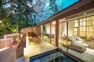 a house with a swimming pool and a living room at Hunter house in Ban Bung Toei