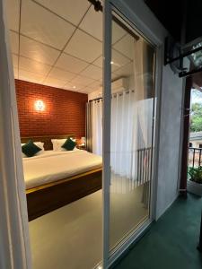a bedroom with a bed and a large window at Sol & Luna in Katunayaka