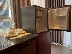 an open refrigerator sitting on a kitchen counter at Sol & Luna in Katunayaka