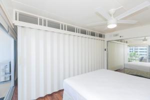 a white bedroom with a bed and a ceiling fan at Ilikai Tower 633 in Honolulu +23 photos