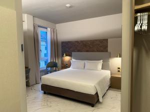 a bedroom with a large white bed and a window at Baires Guest House 2 in Milan
