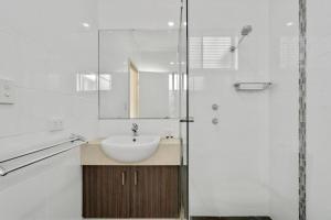a white bathroom with a sink and a mirror at Wroxton Street in Bellevue +43 photos