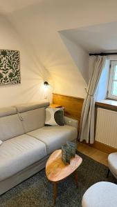 a living room with a couch and a table at B&B La Ferme de l'Hosté in Wavre