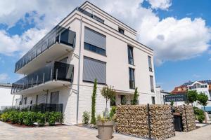 a white building with windows on the side of it at DOM Inn in Mörfelden-Walldorf