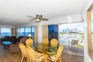 a living room with a table and chairs and a couch at Ilikai Tower 943 in Honolulu